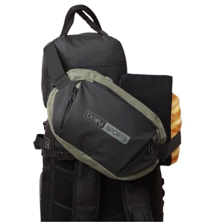 Custom sling bag with flap closure worn crossbody by a Kuala Lumpur commuter