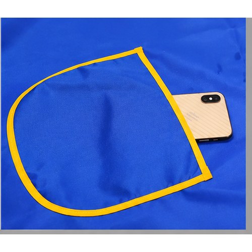 Close-up of the curved front pocket on a contrast-trim apron holding a phone