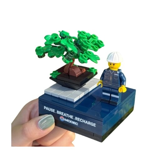 Custom brick minifigure in company uniform on a logo-printed base, Malaysia