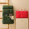 Custom foldable travel organiser in olive green hanging beside a red one and a cabin suitcase, Malaysia