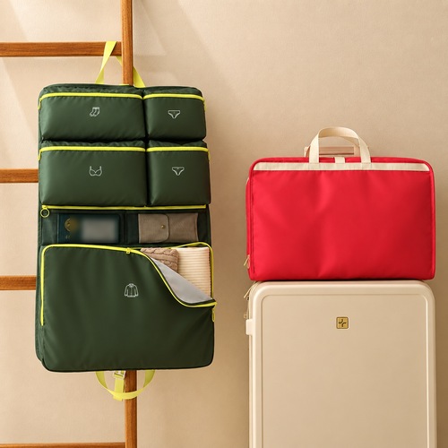 Custom foldable travel organiser in olive green hanging beside a red one and a cabin suitcase, Malaysia