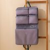 Custom hanging travel organiser in lilac with zip pockets and a cable in the document band, Malaysia