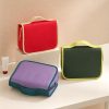 Custom hanging wash bag shown in red, olive green and lilac with contrast trim, Malaysia