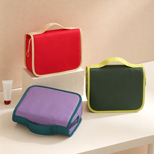 Custom hanging wash bag shown in red, olive green and lilac with contrast trim, Malaysia
