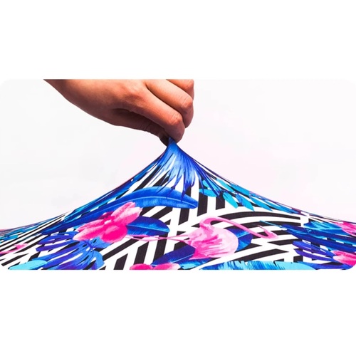 Polyester and spandex luggage cover fabric lifted by hand to show the stretch, Malaysia