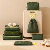 Custom packing cube set beside a cabin suitcase with the drawstring bag hung from the handle, Malaysia