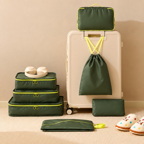 Custom packing cube set beside a cabin suitcase with the drawstring bag hung from the handle, Malaysia