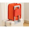 Custom shoe bag slid onto a suitcase trolley handle by its rear sleeve, Malaysia