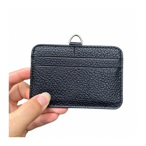 Hand holding a navy pebbled leather pass holder showing back card slots